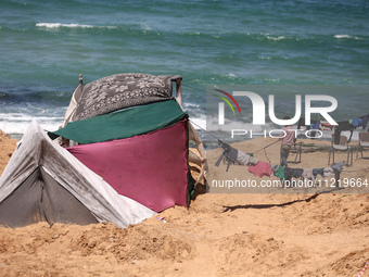 Displaced Palestinians are setting up tents on a beach near Deir el-Balah in the central Gaza Strip amid the ongoing conflict between Israel...