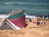 Displaced Palestinians are setting up tents on a beach near Deir el-Balah in the central Gaza Strip amid the ongoing conflict between Israel...