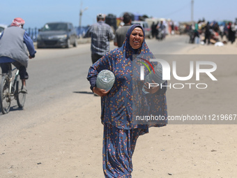 Displaced Palestinians are filling jerrycans with water at a desalination plant in Deir el-Balah in the central Gaza Strip, on May 8, 2024,...