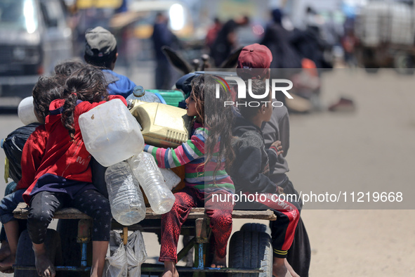 Displaced Palestinians are filling jerrycans with water at a desalination plant in Deir el-Balah in the central Gaza Strip, on May 8, 2024,...