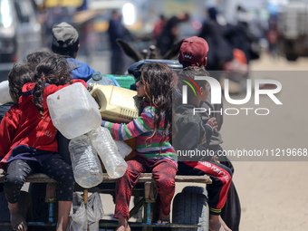 Displaced Palestinians are filling jerrycans with water at a desalination plant in Deir el-Balah in the central Gaza Strip, on May 8, 2024,...