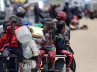 Displaced Palestinians are filling jerrycans with water at a desalination plant in Deir el-Balah in the central Gaza Strip, on May 8, 2024,...