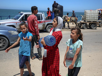 Displaced Palestinians are filling jerrycans with water at a desalination plant in Deir el-Balah in the central Gaza Strip, on May 8, 2024,...