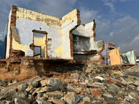 Houses are being destroyed by the ocean tides along Kollamkode Beach in Kollamkode, Kerala, India. (