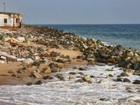 Houses are being destroyed by the ocean tides along Kollamkode Beach in Kollamkode, Kerala, India, on April 15, 2024. (