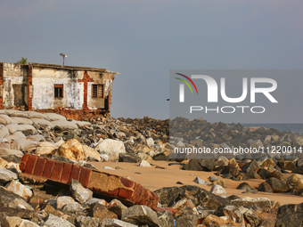 Houses are being destroyed by the ocean tides along Kollamkode Beach in Kollamkode, Kerala, India, on April 15, 2024. (