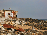 Houses are being destroyed by the ocean tides along Kollamkode Beach in Kollamkode, Kerala, India, on April 15, 2024. (