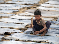 Bablu, who is 8 years old, is working at a tannery to earn one dollar a day in a low-income area in Dhaka, Bangladesh, on May 8, 2024. Altho...