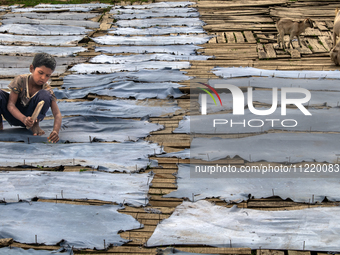 Bablu, who is 8 years old, is working at a tannery to earn one dollar a day in a low-income area in Dhaka, Bangladesh, on May 8, 2024. Altho...