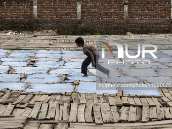 Bablu, who is 8 years old, is working at a tannery to earn one dollar a day in a low-income area in Dhaka, Bangladesh, on May 8, 2024. Altho...