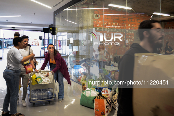 In Lisbon, individuals are gathering hygiene materials, water, clothes, and other items to send on flights to Brazil to address the emergenc...