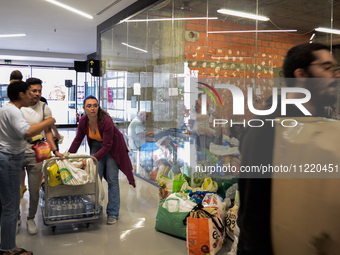 In Lisbon, individuals are gathering hygiene materials, water, clothes, and other items to send on flights to Brazil to address the emergenc...