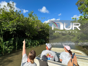 People take part in a boat tour in Everglades National Park, United States on May 6, 2024. (