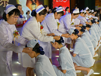 Senior nurses are giving hats to students during a hat-awarding ceremony at a nursing school in Yantai, Shandong Province, China, on May 8,...