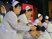 Senior nurses are giving hats to students during a hat-awarding ceremony at a nursing school in Yantai, Shandong Province, China, on May 8,...