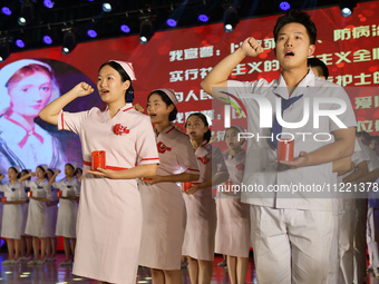 Students are taking an oath during a hat conferring ceremony at a nursing school in Yantai, Shandong Province, China, on May 8, 2024. (