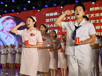 Students are taking an oath during a hat conferring ceremony at a nursing school in Yantai, Shandong Province, China, on May 8, 2024. (