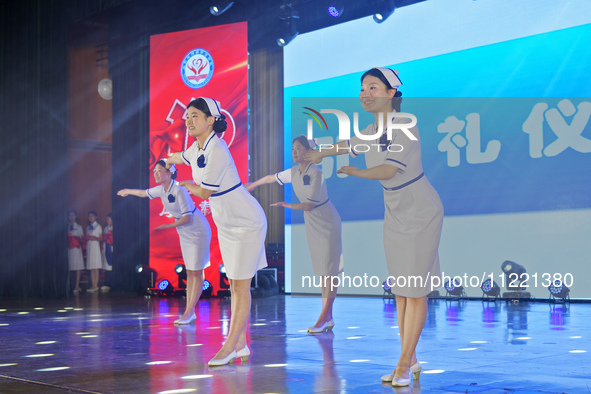 Students are performing etiquette exercises for nurses during a hat-awarding ceremony at a nursing school in Yantai, Shandong Province, Chin...