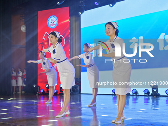 Students are performing etiquette exercises for nurses during a hat-awarding ceremony at a nursing school in Yantai, Shandong Province, Chin...