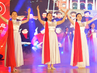 Students are performing a sign language dance during a hat conferring ceremony for Nurses' Day at a nursing school in Yantai, Shandong Provi...