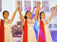 Students are performing a sign language dance during a hat conferring ceremony for Nurses' Day at a nursing school in Yantai, Shandong Provi...