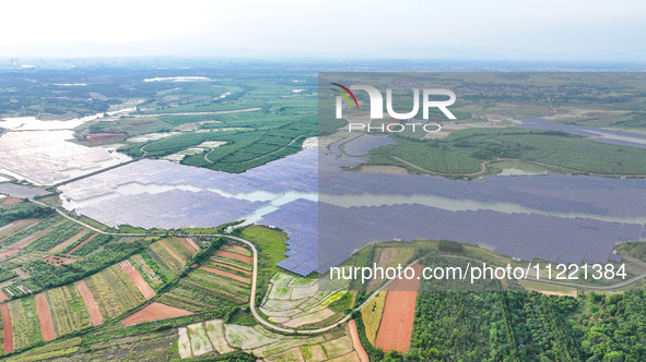 Solar photovoltaic panels are being lined up at the Gaogang Village photovoltaic power generation base in Yichun, China, on May 8, 2024. 