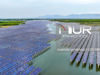 Solar photovoltaic panels are being lined up at the Gaogang Village photovoltaic power generation base in Yichun, China, on May 8, 2024. (