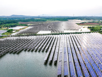 Solar photovoltaic panels are being lined up at the Gaogang Village photovoltaic power generation base in Yichun, China, on May 8, 2024. (