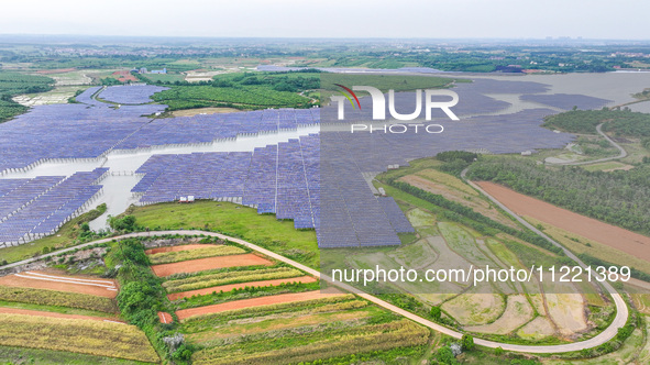 Solar photovoltaic panels are being lined up at the Gaogang Village photovoltaic power generation base in Yichun, China, on May 8, 2024. 