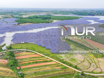 Solar photovoltaic panels are being lined up at the Gaogang Village photovoltaic power generation base in Yichun, China, on May 8, 2024. (