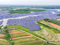 Solar photovoltaic panels are being lined up at the Gaogang Village photovoltaic power generation base in Yichun, China, on May 8, 2024. (