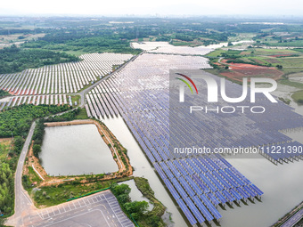 Solar photovoltaic panels are being lined up at the Gaogang Village photovoltaic power generation base in Yichun, China, on May 8, 2024. (