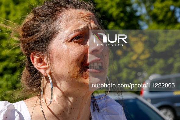 Pro-Ukraine activists shaut and cry as Sergey Andreyev, Russian Ambassador to Poland arrive to lay flowers at the Mausoleum of the Soviet So...