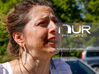 Pro-Ukraine activists shaut and cry as Sergey Andreyev, Russian Ambassador to Poland arrive to lay flowers at the Mausoleum of the Soviet So...