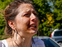 Pro-Ukraine activists shaut and cry as Sergey Andreyev, Russian Ambassador to Poland arrive to lay flowers at the Mausoleum of the Soviet So...