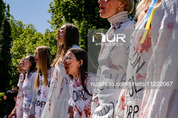 Pro-Ukraine activists shaut and cry as Sergey Andreyev, Russian Ambassador to Poland arrive to lay flowers at the Mausoleum of the Soviet So...