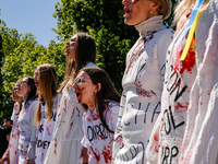 Pro-Ukraine activists shaut and cry as Sergey Andreyev, Russian Ambassador to Poland arrive to lay flowers at the Mausoleum of the Soviet So...