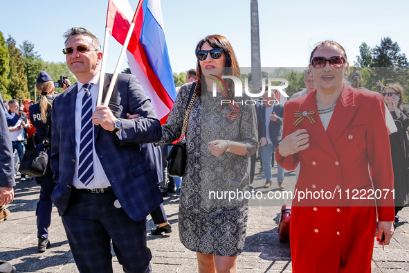 Russians come to lay flowers at the Mausoleum of the Soviet Soldiers Cemetery on Russian Victory Day, May 9, 2024 in Warsaw, Poland. The Rus...