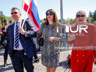 Russians come to lay flowers at the Mausoleum of the Soviet Soldiers Cemetery on Russian Victory Day, May 9, 2024 in Warsaw, Poland. The Rus...