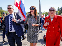 Russians come to lay flowers at the Mausoleum of the Soviet Soldiers Cemetery on Russian Victory Day, May 9, 2024 in Warsaw, Poland. The Rus...