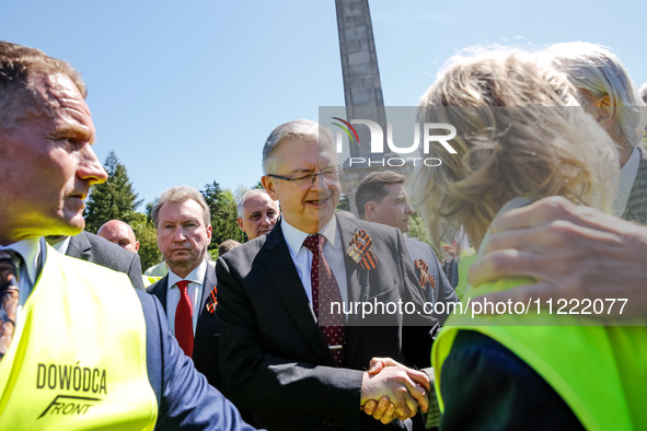 Sergey Andreyev, Russian Ambassador to Poland (C) lays flowers at the Mausoleum of the Soviet Soldiers Cemetery on Russian Victory Day, May...