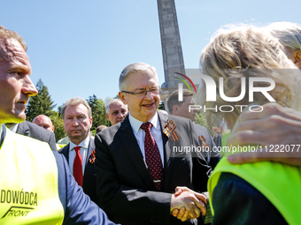 Sergey Andreyev, Russian Ambassador to Poland (C) lays flowers at the Mausoleum of the Soviet Soldiers Cemetery on Russian Victory Day, May...