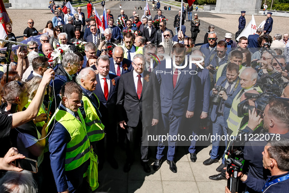 Sergey Andreyev, Russian Ambassador to Poland (C) lays flowers at the Mausoleum of the Soviet Soldiers Cemetery on Russian Victory Day, May...