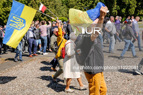 Pro-Ukrain and pro-Russian activists wait for Sergey Andreyev, Russian Ambassador to Poland to arrive to lay flowers at the Mausoleum of the...