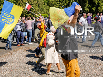 Pro-Ukrain and pro-Russian activists wait for Sergey Andreyev, Russian Ambassador to Poland to arrive to lay flowers at the Mausoleum of the...