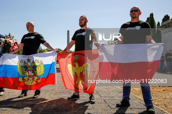 Pro-Russian activists wait for Sergey Andreyev, Russian Ambassador to Poland to arrive to lay flowers at the Mausoleum of the Soviet Soldier...