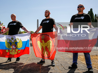 Pro-Russian activists wait for Sergey Andreyev, Russian Ambassador to Poland to arrive to lay flowers at the Mausoleum of the Soviet Soldier...