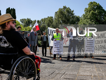 Pro-Russian activists wait for Sergey Andreyev, Russian Ambassador to Poland to arrive to lay flowers at the Mausoleum of the Soviet Soldier...