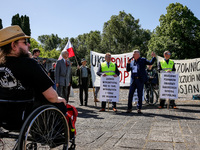 Pro-Russian activists wait for Sergey Andreyev, Russian Ambassador to Poland to arrive to lay flowers at the Mausoleum of the Soviet Soldier...