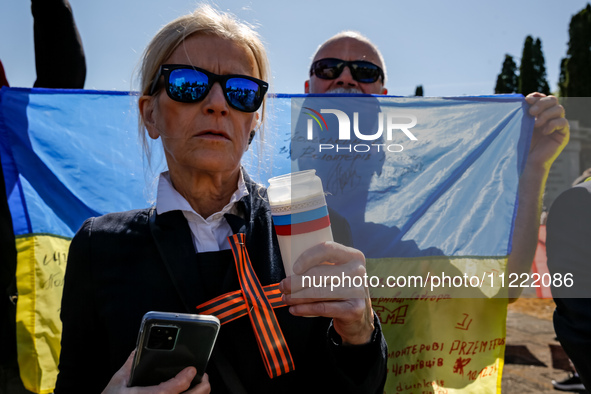 Pro-Ukrain and pro-Russian activists wait for Sergey Andreyev, Russian Ambassador to Poland to arrive to lay flowers at the Mausoleum of the...